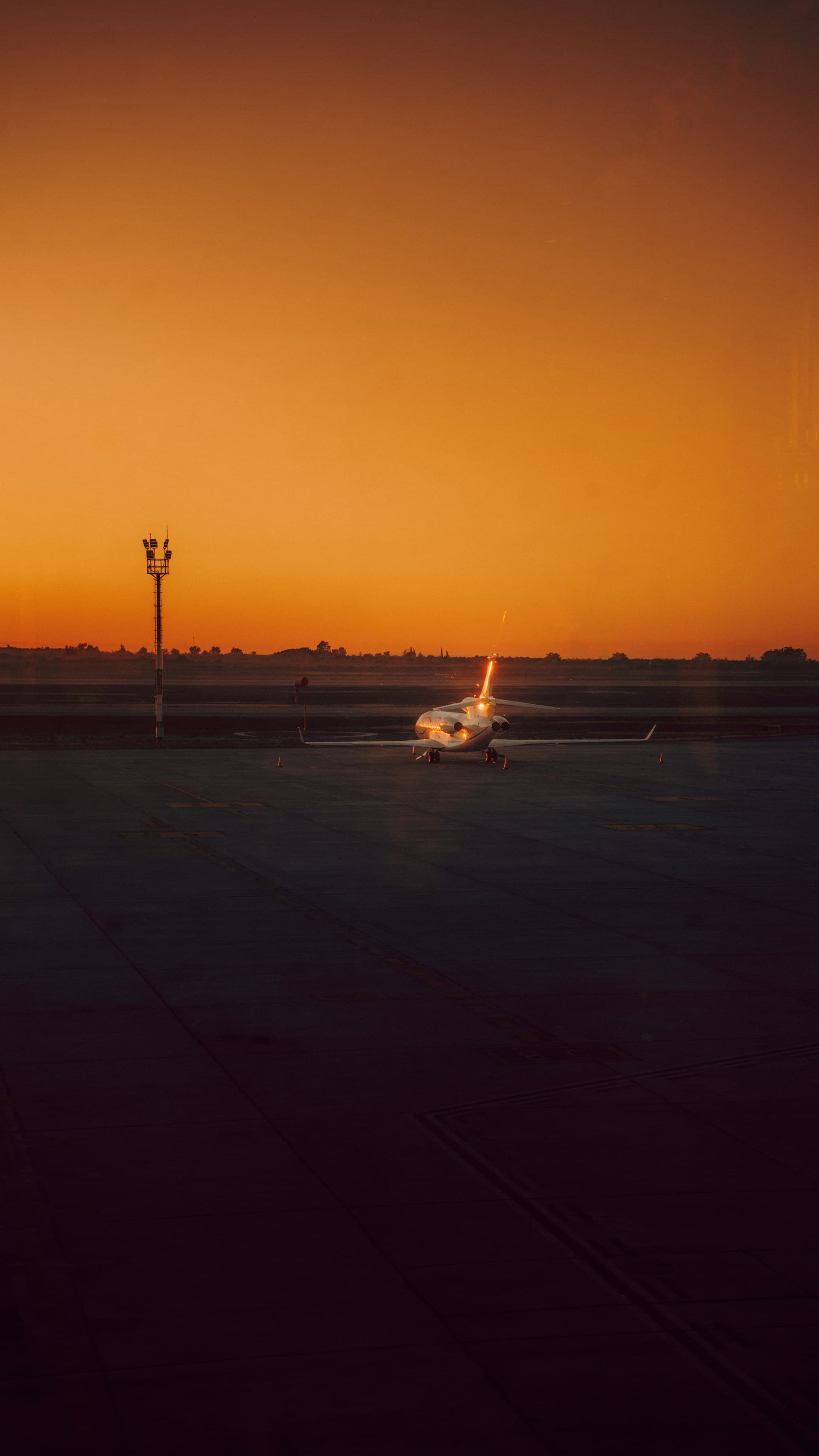 A private jet on the tarmac at sunset